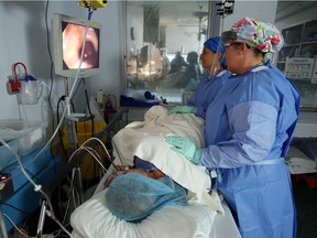 Dr. Susanne Faroogui and an OR nurse, right, perform a colonoscopy on Dr. Sheila Horen at the hospital in Leamington on Sept. 30, 2016.