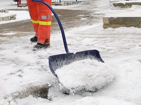 A city of Windsor worker shovels snow in this January 1, 2014 file photo.