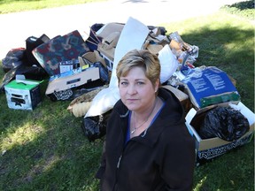 Kelly Caruana stands in front of her east Windsor home on October 10, 2016.   Caruana's home fell victim to the recent flood and she lost most of her belongings that were in the basement.   Caruana is questioning why people are taking the sewage-soaked goods that she has discarded on her front lawn.