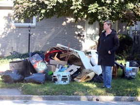 Kelly Caruana stands in front of her east Windsor home on October 10, 2016.   Caruana's home fell victim to the recent flood and she lost most of her belongings that were in the basement.   Caruana is questioning why people are taking the sewage-soaked goods that she has discarded on her front lawn.