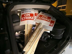 Picket signs are loaded at Unifor Local 444 in Windsor, Ontario, as union members await the result of negotiations with FCA on Oct. 10, 2016.