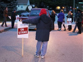 Pickets speak with motorists as they enter Windsor-Essex Catholic District School Board meeting on Oct. 25, 2016.