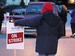 Support staff workers on strike speak with motorists as they enter a Windsor-Essex Catholic District School Board meeting on Oct. 25, 2016.