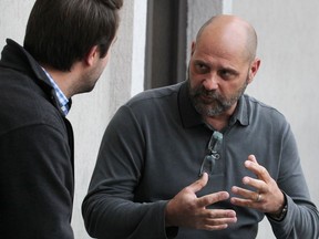 Renowned shipwreck hunter and shipwreck historian Richie Kohler, right, has an animated conversation with Windsor Star reporter Dan Taekema at Fogolar Furlan Club on Oct. 28, 2016.