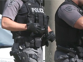 A Windsor police Emergency Services Unit officer holds a pellet handgun seized from a person following a takedown on Giles Avenue West near Pelissier Street in Windsor on Oct. 4, 2016.