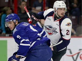 Mississauga's Michael McLeod, left, tangles with Windsor's Logan Brown in OHL action from WFCU Centre on Oct. 6, 2016.