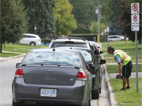 WINDSOR, ONTARIO - SEPT 21, 2016 - Municipal By-Law officers were issuing tickets to standing vehicles near Massey Secondary School on Wednesday September 21, 2016 in Windsor, Ontario (JASON KRYK/Windsor Star)  (SEE STORY BY TREVOR WILHELM on TRAFFIC CONCERNS BEFORE AND AFTER SCHOOL)