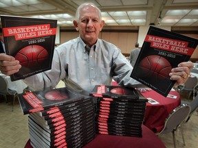 Author Bob Turner displays the new book Basketball Rules Here, Windsor's Encyclopedia of Basketball during a book launch at Giovanni Caboto Club of Windsor September 30, 2016.