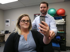 Dr. Dean Tapak, a chiropractor at Performance Health in Windsor, says poor posture while using a cellphone or tablet can cause neck pain, called text neck. Michelle McKillican is shown receiving treatment.