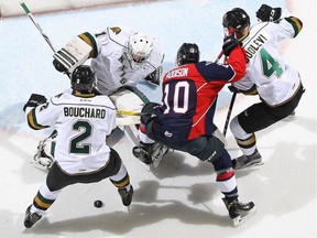 Jeremiah Addison (10) of the Windsor Spitfires is stopped by London Knights goalie Tyler Parsons the during an OHL game at Budweiser Gardens on October 14, 2016 in London, Ontario.
