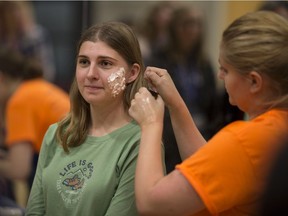 Lauren Buckley, right, a fourth-year dramatic arts student applies zombie makeup to Nikole Otcenasek, 19, a second-year biology student, at the University of Windsor's Interdisciplinary Approaches to Solving the Zombie Apocalypse, Saturday, Oct. 29, 2016.
