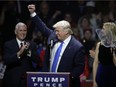 Republican presidential candidate Donald Trump acknowledges his supporters between vice presidential nominee, Indiana Gov. Mike Pence, left, and his daughter Ivanka, right, at a campaign rally, Monday, Nov. 7, 2016, in Manchester, N.H. (AP Photo/Charles Krupa)