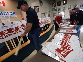 Unifor Local 444 members prepare strike signs for potential work action on Wednesday, November 2, 2016, at the Turner Rd. union hall in Windsor, ON. The Integram Magna Seating workers shown are Lloyd Phillips (L), Scott Bonnett, Rob Burgess and Jamie Pollard.