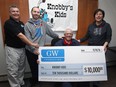 The Knobby's Kids organization which helps needy children play hockey in Windsor received a $10,000 donation from the Gary Wilson Foundation on Thursday, November 10, 2016. Marty Kerester, left, and Jerry Slavik, seated, members of the Knobby's Kids organization received the cheque from Gary Wilson and his mother Heather Wilson.