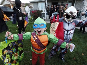 Full of energy, Gavin Hiller, 4, left, and Hudson Jack Wright, 5, leave Gina Coulter's Halloween party on Acorn Cres.