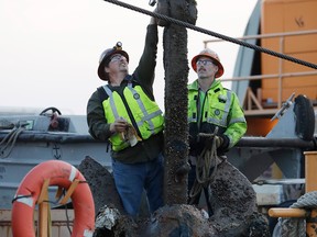 A Salvage crew recovers a 6,000-pound anchor, Tuesday, Nov. 15, 2016, in the Detroit River in Detroit. The anchor, from the Greater Detroit, has rested on the river bed for six decades. Once cleaned and restored, it will be displayed at the Detroit/Wayne County Port Authority downtown.