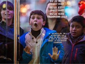 NEW YORK, NY - NOVEMBER 27:  A boy waits to enter the Toys R Us in Times Square on November 27, 2014 in New York, United States. Black Friday sales, which now begin on the Thursday of Thanksgiving, continue to draw shoppers out for deals and sales.