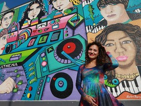 Windsor mural artist Briana (Athena) Benore in front of her latest and most ambitious work to date: A giant music-inspired piece on the side of the Cool 100.7 FM building at 2090 Wyandotte St. East in Walkerville. Photographed Nov. 15, 2016.