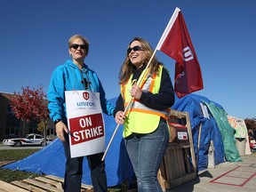 Kim Gosling, left, and Erin Malone-Walls, both campus ministers with the Windsor-Essex Catholic District School Board, are shown on the picket line on Nov. 7, 2016, at St. Joseph's Catholic High School in Windsor,