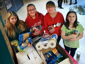 The students at the LaSalle Public School held a food drive to help the local Welcome Centre Shelter for Women organization. They collected hundreds of cans and dry goods for the group. Students Amber Musson, left, Natalie Dupuis, Paige Dupuis and Cathy Gazo pose with some of the goods on Nov. 28, 2016 at the LaSalle school.