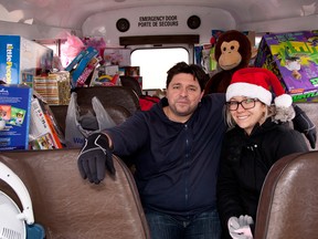 Organizer Carlos Delgado and volunteer Michelle Matias were inside Carlos’ Bus Toy Drive, sponsored by the Windsor-Essex Children’s Aid Society, collecting toys, canned food and clothes in Leamington.