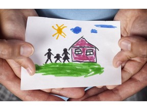 Child and his mom holding a drawn house with family. Close up. Vignette.