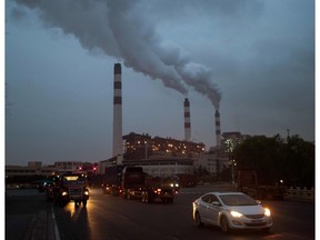 Cars pass the Shanghai Waigaoqiao Power Generator Company coal power plant in Shanghai on March 22, 2016.    Environmental watchdog Greenpeace warned on March 22 the worlds coal plants are deepening the global water crisis as the water consumed by them can meet the basic needs of one billion people. /