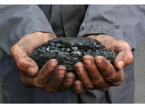 Coal in the hands of a miner. Photo by Getty Images.