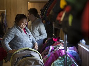 Parents search for winter coats for their children during the annual Coats for Kids campaign at the Unemployed Help Centre on Nov. 12, 2016.