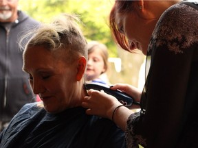 D.J. Meadows has her head shaved by her daughter, Shannon Murray, prior to her major eight-hour brain surgery called deep brain stimulation in June 2016.