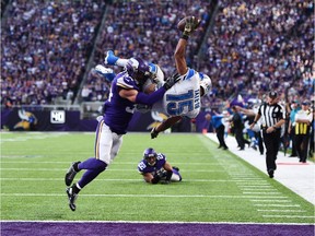 Golden Tate #15 of the Detroit Lions leaps into the end zone for the go ahead touchdown while being tackled by Andrew Sendejo #34 of the Minnesota Vikings during overtime on November 6, 2016 at US Bank Stadium in Minneapolis, Minnesota.