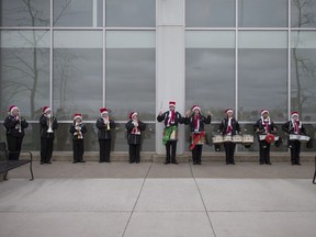 The Diplomats Drum and Bugle Corps perform outside the Real Canadian Superstore on Walker Rd., in order to collect food items for area food banks, Saturday, Nov. 26, 2016.