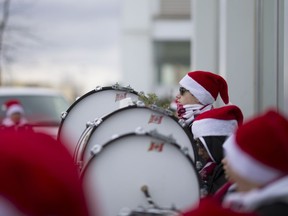 The Diplomats Drum and Bugle Corps perform outside the Real Canadian Superstore on Walker Rd., in order to collect food items for area food banks, Saturday, Nov. 26, 2016.
