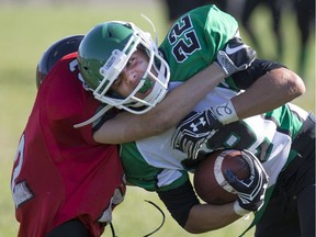 Herman's Austin Thorton is tackled by Essex's Joshua Cecile during WECSSAA high school football action at Herman Secondary School on Sept. 20, 2016.