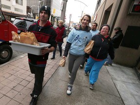 WIndsor Youth Centre volunteers (left to right) William Campbell, Amber Millar, and Patricia Caron roam downtown Windsor looking to give away burrito lunches to hungry folks in need on Nov. 24, 2016.