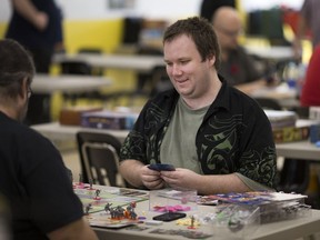 Sean Hamilton and Maurice Tousignant, left, play a board game at the Extra Life fundraiser for the Children's Miracle Network at Brimstone Games, Saturday, Nov. 5, 2016.