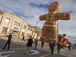 Participants in the Downtown Windsor Winter Fest parade of November 2015 lead a giant inflatable gingerbread man down Ouellette Avenue in this file photo.
