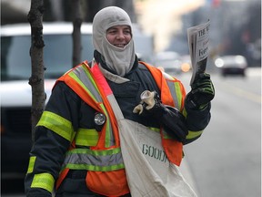 WINDSOR, ON. NOV. 27, 2014. Goodfellow and Windsor firefighter Daniel Sloan sells newspapers on Ouellette Ave. in Windsor, ON. on Thursday, Nov. 27, 2014.  (DAN JANISSE/The Windsor Star)