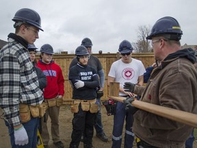 St. Joseph's teacher Cory McAiney works with students from the school at a Habitat for Humanity house in Leamington on Nov. 24, 2016.