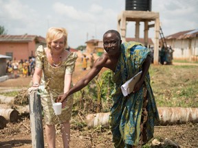 Kim Spirou gets water from a well with the chief of the village of Jakai, in the Central Region of Ghana in 2015.