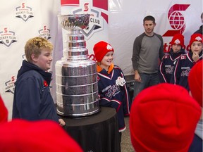 Members of the Riverside Rangers atom major travel team get a close up look at the Stanley Cup at the Hometown Hockey Tour at the Riverfront Festival Plaza, Saturday, Nov. 19, 2016. The team was chosen at random for a private look at the Stanley Cup.