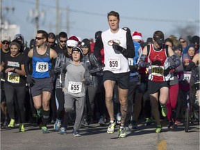 Runners and walkers leave the starting line of the 22nd annual Jingle Bell Run in support of Community Living Essex County, in downtown Essex, Sunday, November 13, 2016.