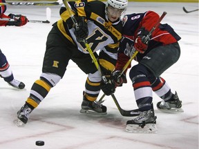 Kingston Frontenacs Nathan Dunkley ties up Windsor Spitfires Connor Corcoran during Ontario Hockey League action at the Rogers KRock Centre in Kingston, Ont., on Nov. 27, 2016.