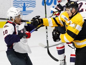 Forward Warren Foegele (3) of the Kingston Frontenacs battles after the whistle against forward Jeremiah Addison (10) of the Windsor Spitfires on Oct. 20, 2016 at the WFCU Centre in Windsor, Ont.