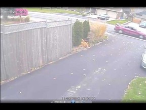 A security camera image showing a red Pontiac Grand Am that was involved in a daytime break-in on Laurier Drive on Nov. 8, 2016. Note the 60-inch television set sticking out of the open trunk.