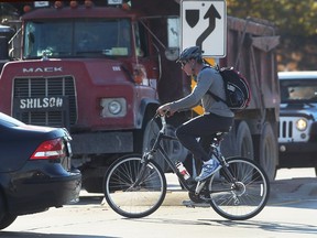 A cyclist crosses Tecumseh Road East at Lauzon Parkway on  Nov. 7, 2016. The intersection has been identified as one of the worst for cyclist versus car collisions.