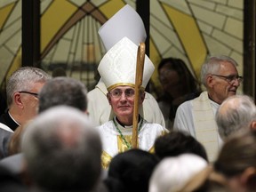 Bishop Ronald P. Fabbro, centre, and Rev. Patrick Fuerth, pastor of St. Michael's Parish, arrive for the dedication of new St. Michael the Archangel Parish in Leamington Friday. The parish broke ground in July 2015 on the $10 million building on Elliott Street. It replaces the former St. Michael’s church building and St. Joseph’s Church.