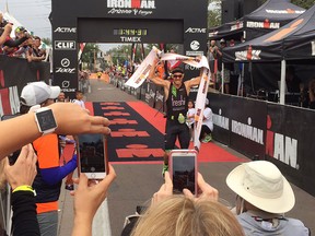 Harrow native Lionel Sanders crosses the finish line to set a new world record during the Ironman Arizona competition on Nov. 20, 2016 in Tempe, Ariz.