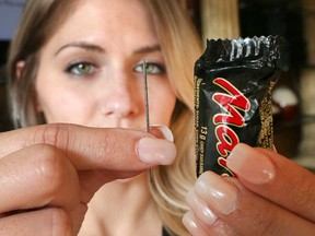 Windsor mother Angela Magyar shows the sewing needle she says she discovered in a piece of chocolate from her young daughter's trick-or-treat haul. Photo taken Nov. 1, 2016.