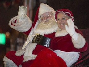 Santa Claus and Mrs. Claus wave to the spectators lining Manning Road during the Tecumseh Santa Parade, Friday, Nov. 25, 2016.